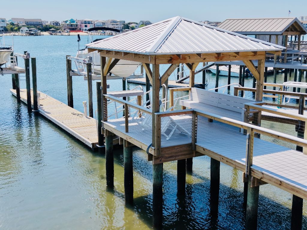 Hip-roof covered dock with cable railings and floating dock